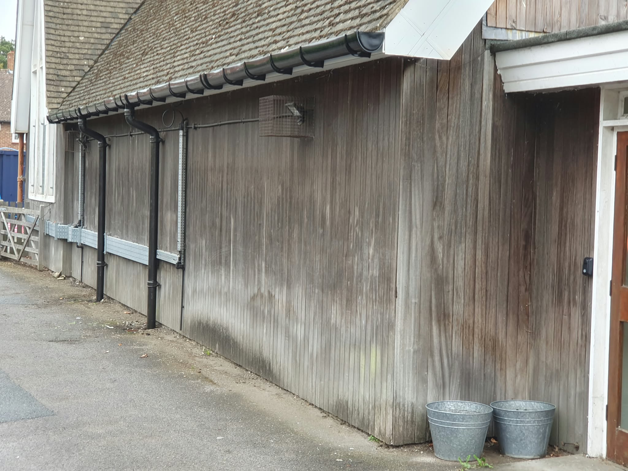 The new plastic guttering and restored black cast iron downpipes